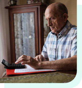 Older man using calculator