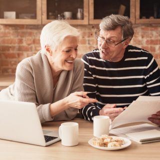 Happy older couple reviewing investments