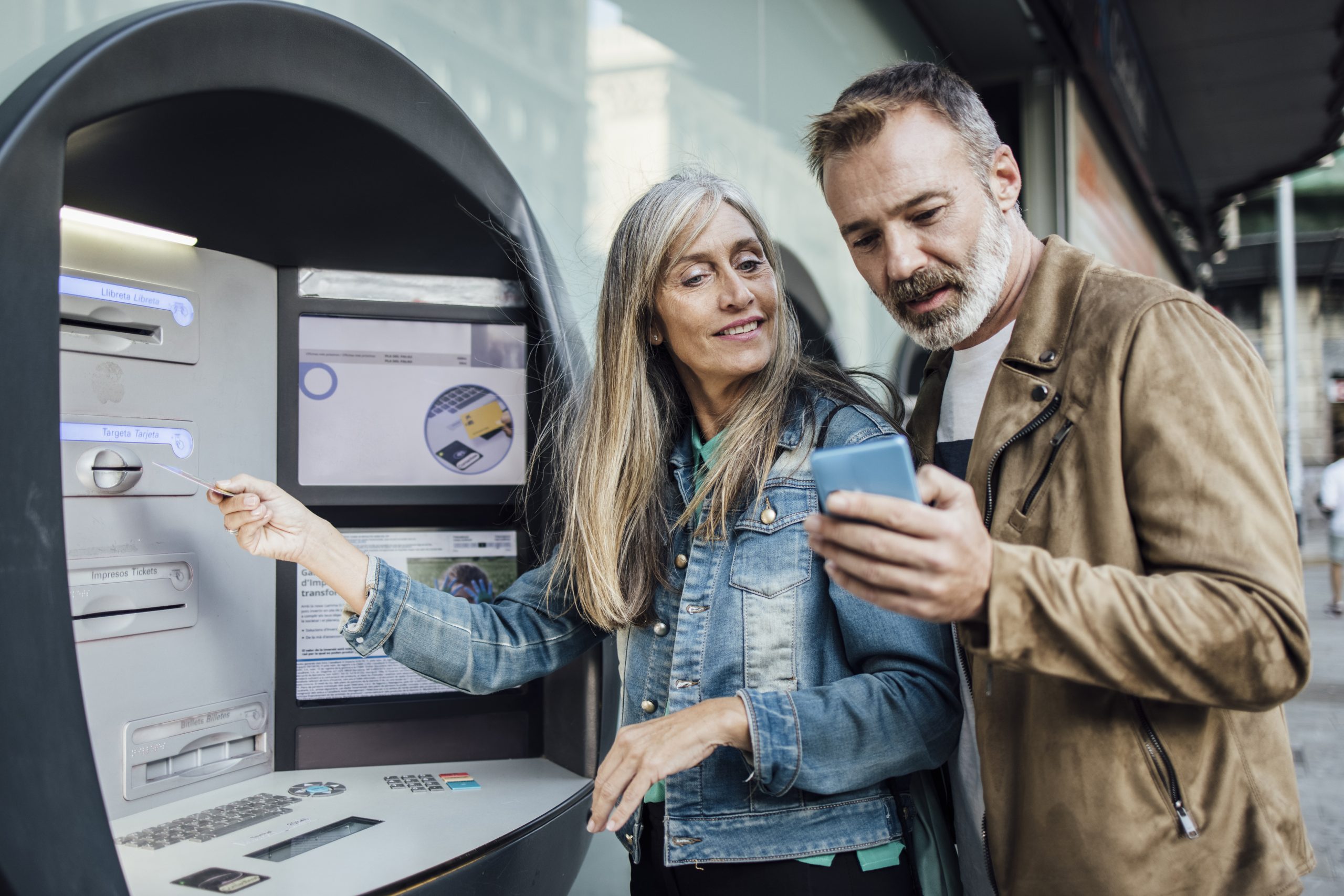 Portrait of a mature couple using their bank ATM.