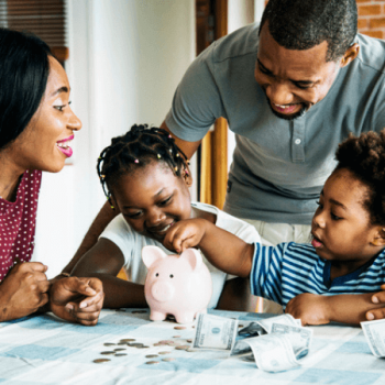 Black mother and father teaching their daughter and son about saving money